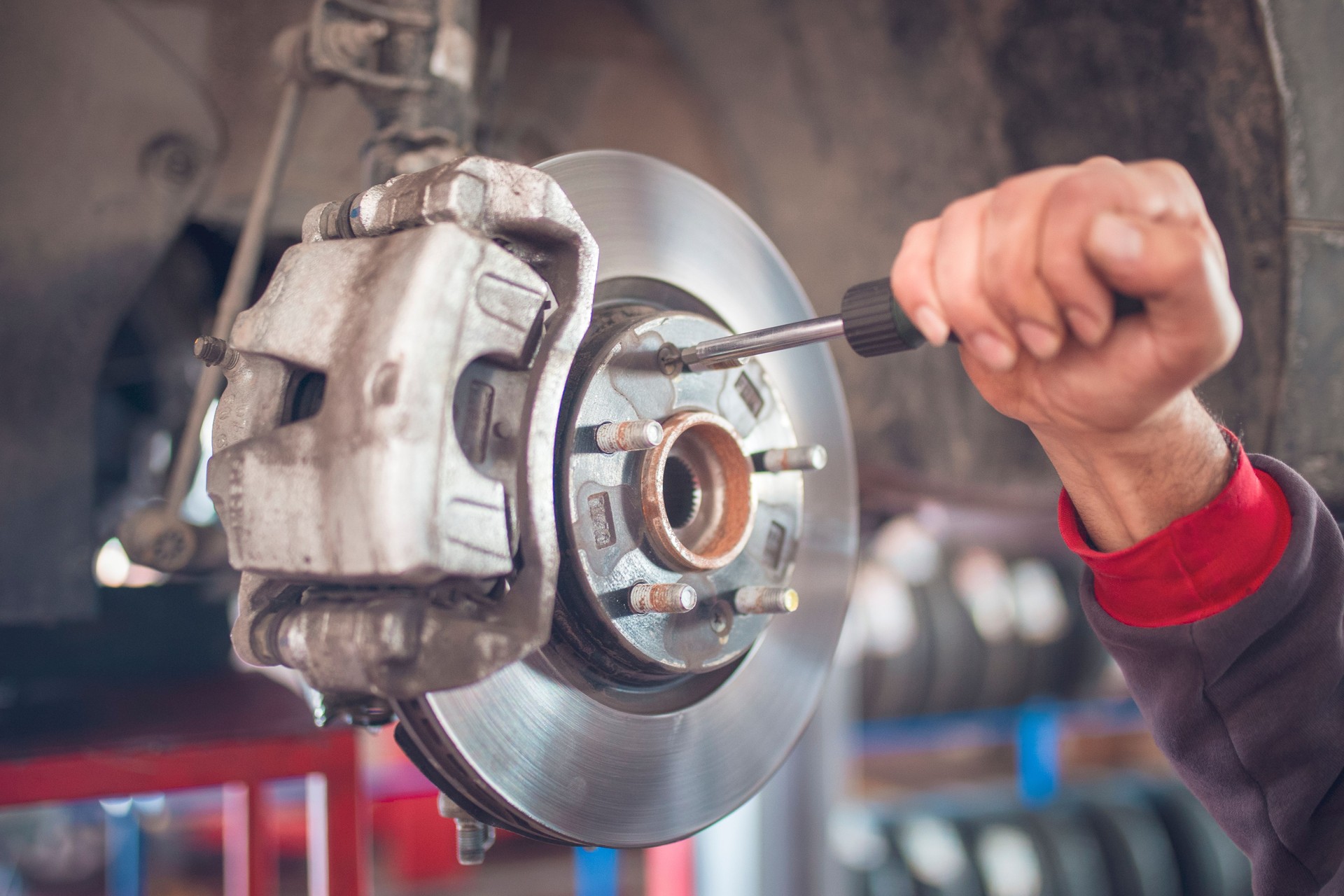 The mechanic is repairing the brake wheels.